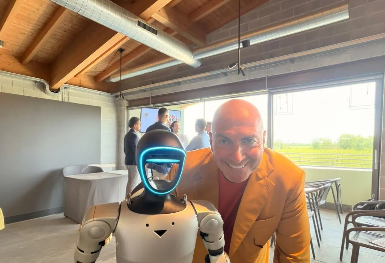 Franco Boriani accanto a un robot umanoide